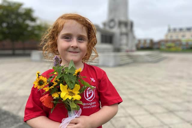 Emily Birbeck, from Hartlepool's Central Estate, laying flowers at Victory Square following the death of Her Majesty Queen Elizabeth II. Picture by FRANK REID