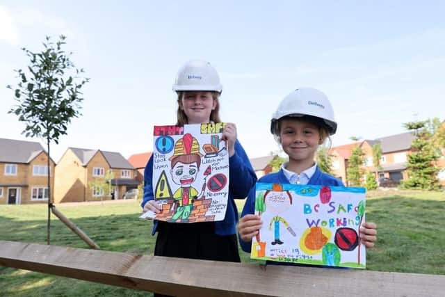 Hattie and Libby from Wingate Primary School with the posters they designed to win the Bellway art competition.