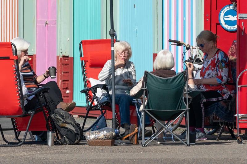 Members of the University of the Third Age iPhone photography group take advantage of the easing of lockdown and unseasonably warm weather to have an impromptu get together at Roses beach hut at Hove Lawns on March 30, 2021 in Brighton, England. (Photo by Chris Eades/Getty Images)