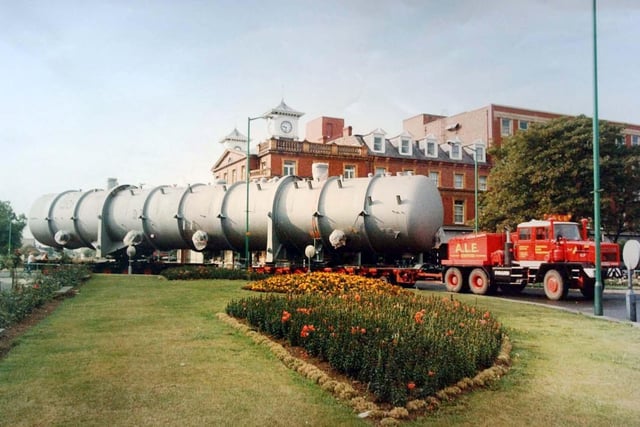 This photograph shows a large truck from Foster Wheeler's factory, in Brenda Road, being hauled slowly through the town centre.