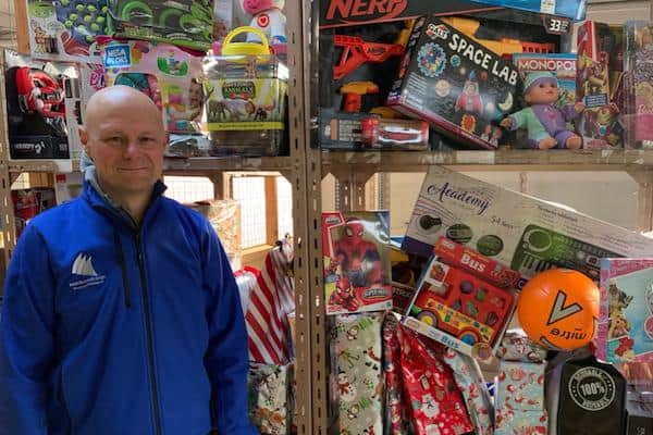 Middleton Grange manager Mark Rycraft with just some of the 174,000-plus presents donated towards its annual Giving Tree Appeal.