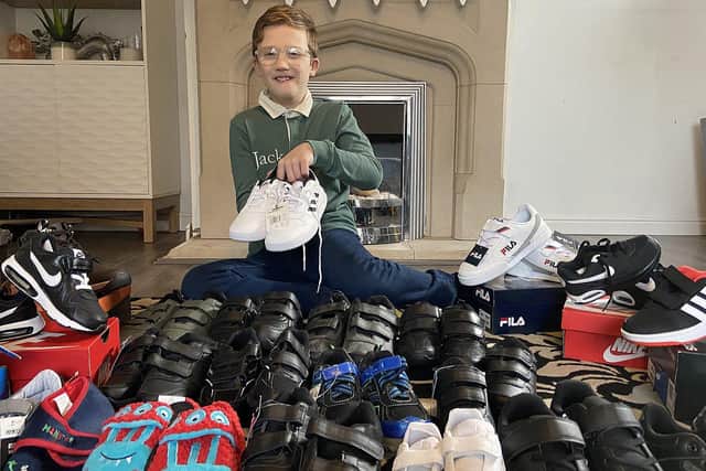 Jett Kilvington, 9, with a selection of shoes he wants to donate.