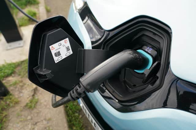 An electric vehicle charging at a recharging point. Picture by PA.