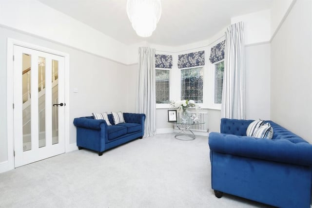 This cosy family room has a lovely bay window looking out over the property's wooded land.