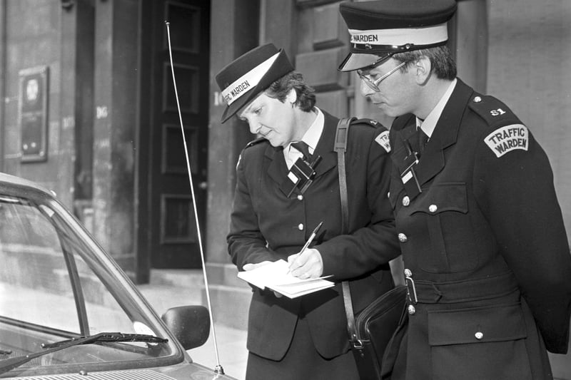 Edinburgh traffic wardens Lesley Temperley and Michael McPheely inspect a car's tax disc in June 1987 in a picture taken to celebrate 25 years of traffic wardens in the Capital.