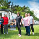 Christine Fewster, pictured third from the right, outside the respite caravan in Northumberland, alongside the Cooper family.