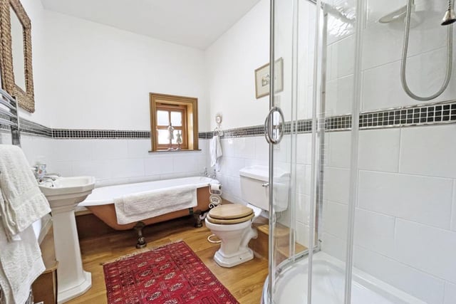 The family bathroom features a walk-in shower and a freestanding bath.