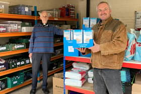 Stephen Close, Hartlepol History DVD Charity group treasurer presents a donation of 200 boxes of oats to Rev Andrew Craig of Hartlepool Foodbank.