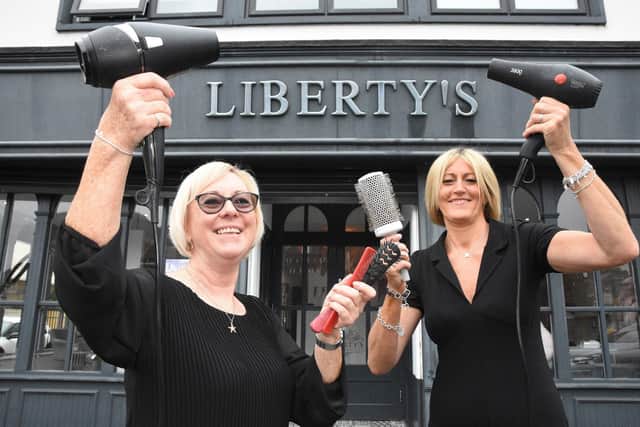 Sue Hunt, left, with the owner of Liberty's Hair and Beauty, Tracy Lancaster, right.
