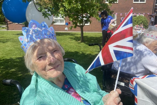 Jean Connell shows off her flag and crown.