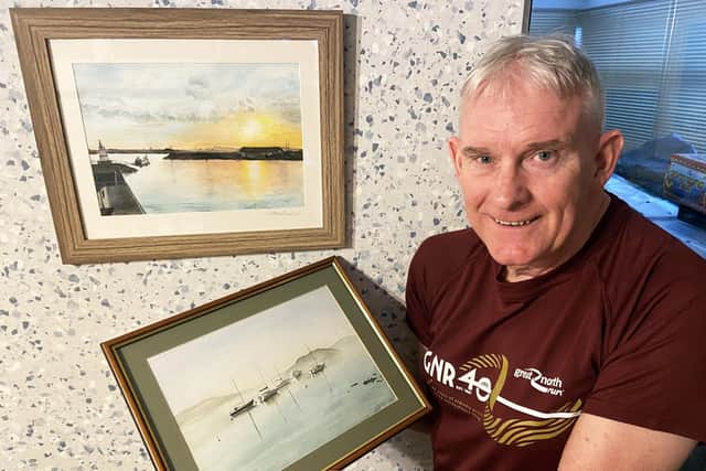 Phil Holbrook with paintings done by his late wife Gillian. Picture by FRANK REID. 