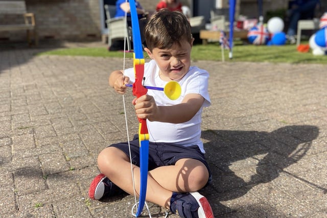 Noah Hutchinson with his bow and arrow during the Queen's Jubilee celebrations at Mildenhall Close.