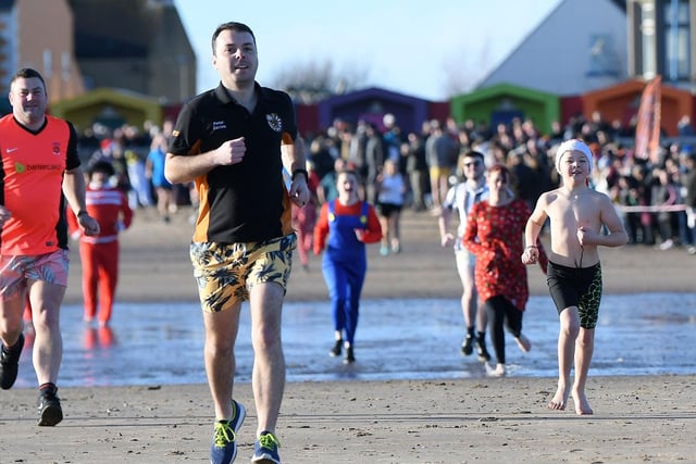 Dippers run down the beach towards the sea for the Boxing Day Dip at Seaton Carew. Picture by FRANK REID