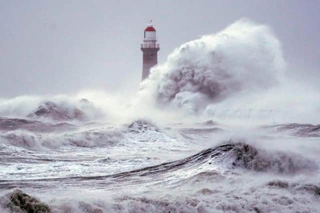 Huge waves crash the against the sea wall and Roker Lighthouse in Sunderland in the tail end of Storm Arwen which saw gusts of almost 100 miles per hour battering areas of the UK. Picture date: Saturday November 27, 2021.