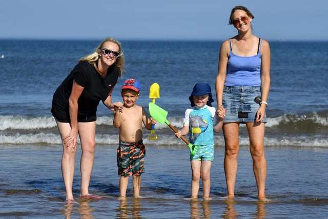 From left, Kate Vickers with her son Harry Martin and Catherine with her son Ciaran plodging in the water. Picture by FRANK REID.