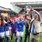 Hartlepool United owner Raj Singh celebrates with the trophy after winning the shoot-out and promotion after the Vanarama National League play-off final at Ashton Gate, Bristol (photo: Nigel French)