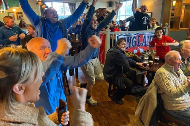 Fans at The Park Inn celebrate England scoring in their World Cup match against Iran.