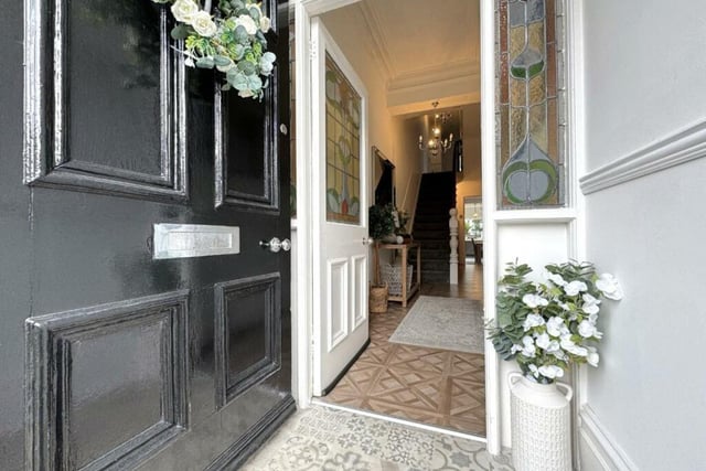 This entrance lobby has a stunning stained glass internal door and matching side screens.