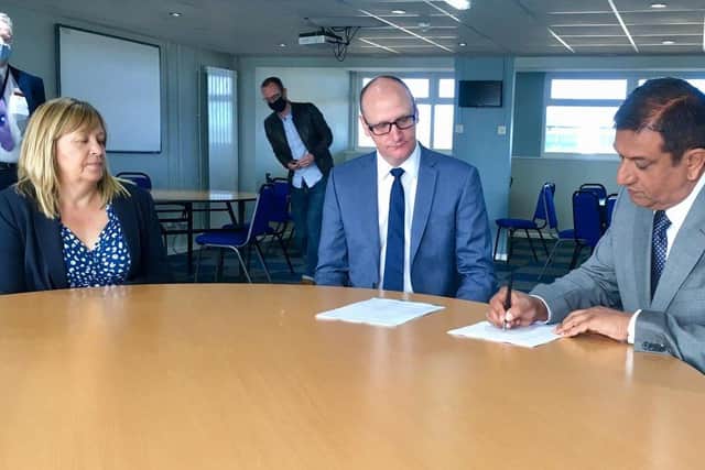 Hartlepool United chairman Raj Singh (right) signs the Memorandum of Understanding at Victoria Park with Cllr Shane Moore and Hartlepool Borough Council managing director Denise McGuckin.