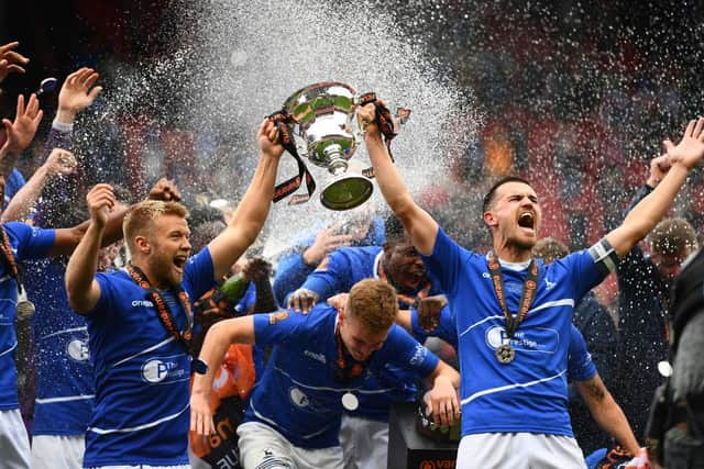 Nicky Featherstone and Ryan Donaldson of Hartlepool United lift the Vanarama National League Trophy during the Vanarama National League Play-Off Final match between Hartlepool United and Torquay United at Ashton Gate on June 20, 2021 in Bristol, England. (Photo by Harry Trump/Getty Images)