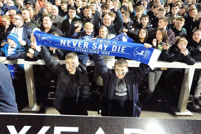 Young fans proudly hold a scarf during the Papa John's Trophy semi-final clash with Rotherham United in 2022.