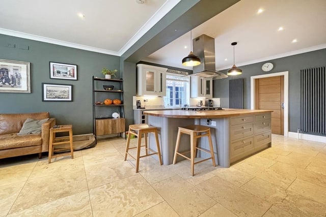 This kitchen is open plan, encompassing the dining room and a large sofa, perfect for entertaining friends and family.