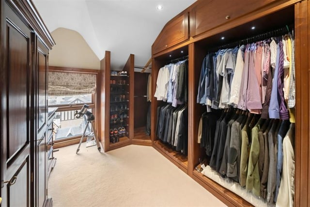 The walk-in dressing room is currently used as a gentleman's wardrobe.