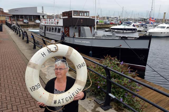 Pauline Field in front of the newly restored MV Coronia which has been renamed HM Watchful in recognition of her war service.