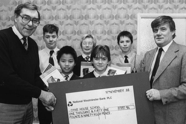 Dyke House headmaster Mr Ramsden (left) is given a cheque from the Dyke House Parent Teachers Association from a sponsored run that took place in 1988.