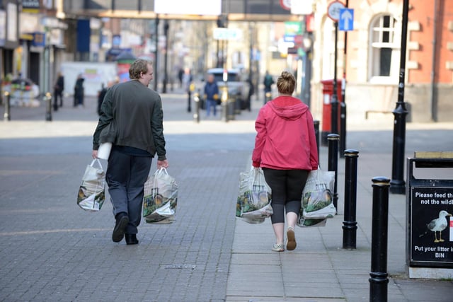 Shoppers stick to social distancing as they head home with supplies.