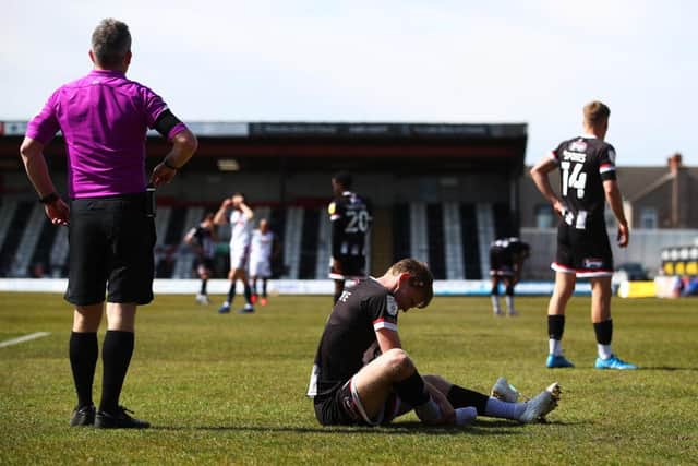Luke Hendrie of Grimsby Town injured during the Sky Bet League Two match between Grimsby Town and Bolton Wanderers at Blundell Park on April 17, 2021 in Grimsby (Photo by Joe Portlock/Getty Images)