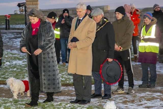 Dignitaries brave the freezing conditions to pay their respects.