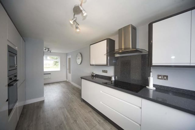 The kitchen has been fitted with multiple appliances including an oven, hob and a dishwasher.