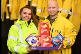 Hartlepool RNLI volunteer crew member Chandler Wilson handing over some of the chocolate eggs to Tony Hudspith./Photo: RNLI/Tom Collins