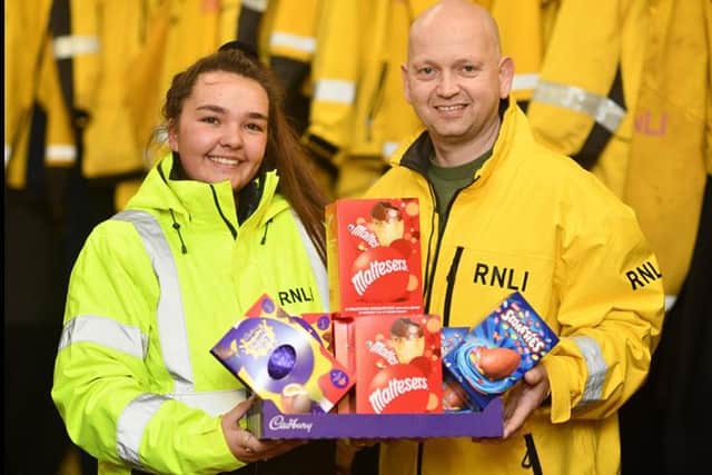 Hartlepool RNLI volunteer crew member Chandler Wilson handing over some of the chocolate eggs to Tony Hudspith./Photo: RNLI/Tom Collins