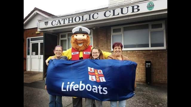 Hartlepool RNLI mascot Stormy Stan pictured with RNLI supporters (left to right) Ann Graham, Toni-Kate Bousfield and Marie Bousfield outside the Catholic Club./Photo: RNLI/Tom Collins