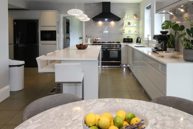 This home has a large and modern kitchen, featuring a stunning breakfast bar.