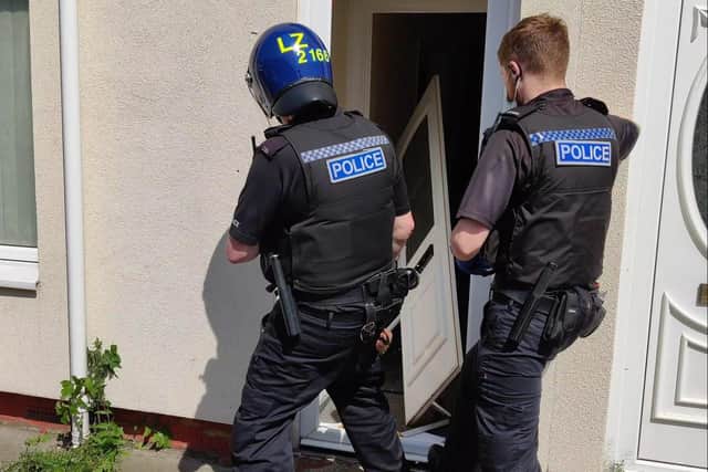 Police force a door in the Oxford Road area of Hartlepool in May.