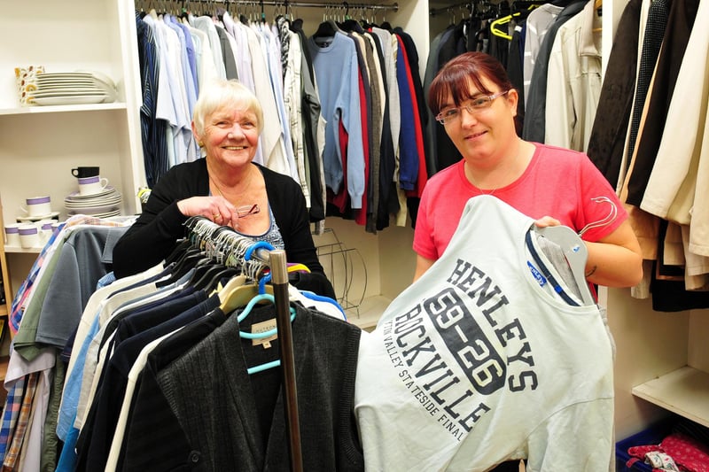 Brenda Buck volunteer and Julie Bell sort clothes at Murray Street's charity shop in 2014.