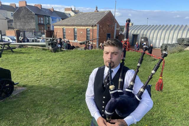 Piper Chris Pearson plays for the final time at the Hugh Battery Museum on the Headland on the day of the Queen's state funeral. Picture by FRANK REID