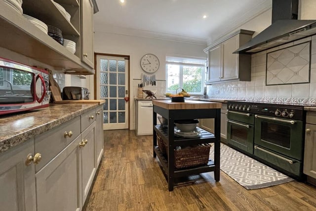 The kitchen benefits from a moveable centre island and a range of appliances.
