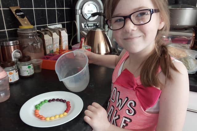 Alicia Hunter, 10, with her science experiment - Sweet Science - that she received in one of the ATOMS kits.