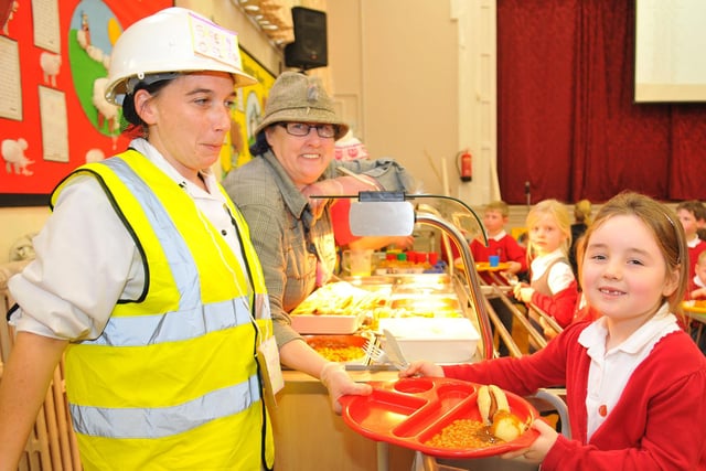 Sacred Heart Primary School pupil Skye Duffield is served lunch by Jackie Hart (left) and Anette Bain. Remember this from 2019?