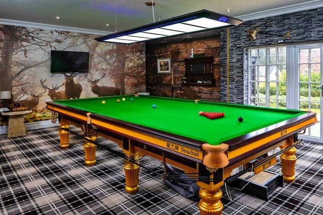 This home has a range of hobby rooms, including a billiard room leading out into the gardens.