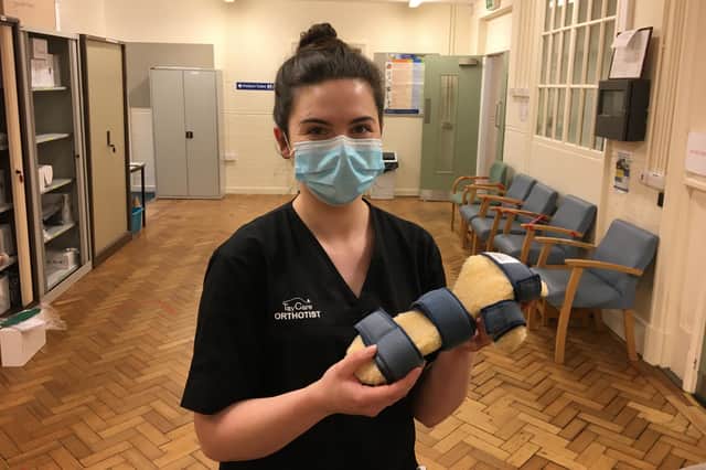 Orthotist Abby Paterson holds an arm splint.