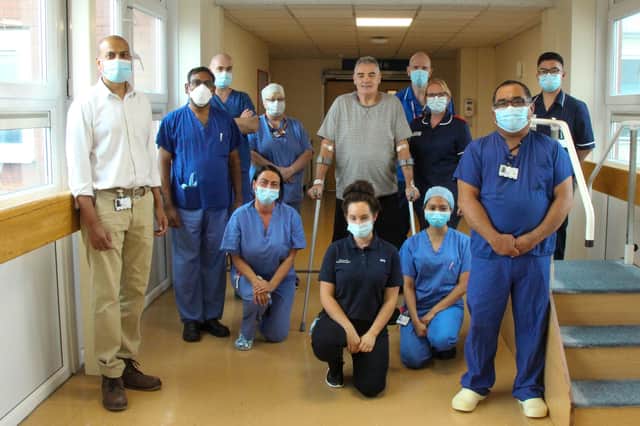 Consultant orthopaedic surgeon Manju Ramappa, left, with some of the operating theatre team and hip replacement patient Sam Robinson, centre.