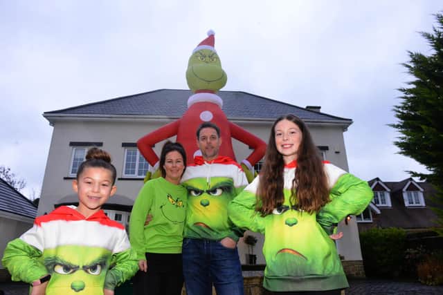 The Liddell family outside their Hartlepool home with their giant Grinch. Ray and wife Jenna are pictured with daughters Jasmine, left, and Olivia.