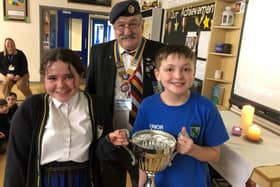Rotary Hartlepool president Wally Stewart presents the trophy St Peter's Elwick pupils Autumn and Josh.