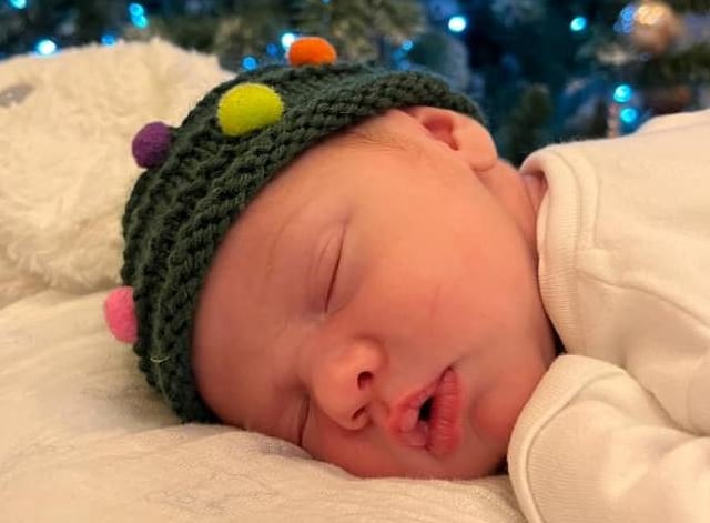 Joey, age 1 week, wanted to make sure he didn't miss out on any Christmas gifts this year ...
