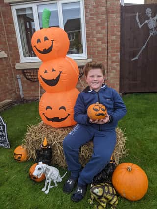 Louise's son, Monty, 8, with Halloween decorations ahead of the charity event.